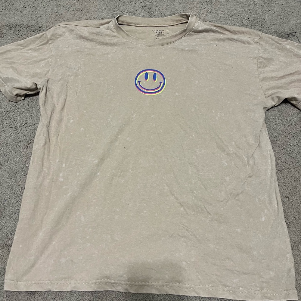 Super cute tan shirt with bright details. Worn once.